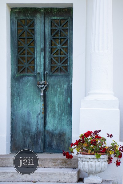 old teal door chained closed and weathered with time